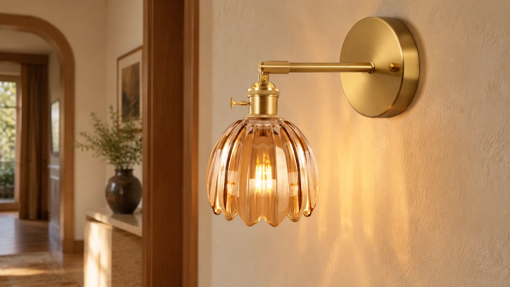 Antique brass tulip glass wall light installed in a warm hallway