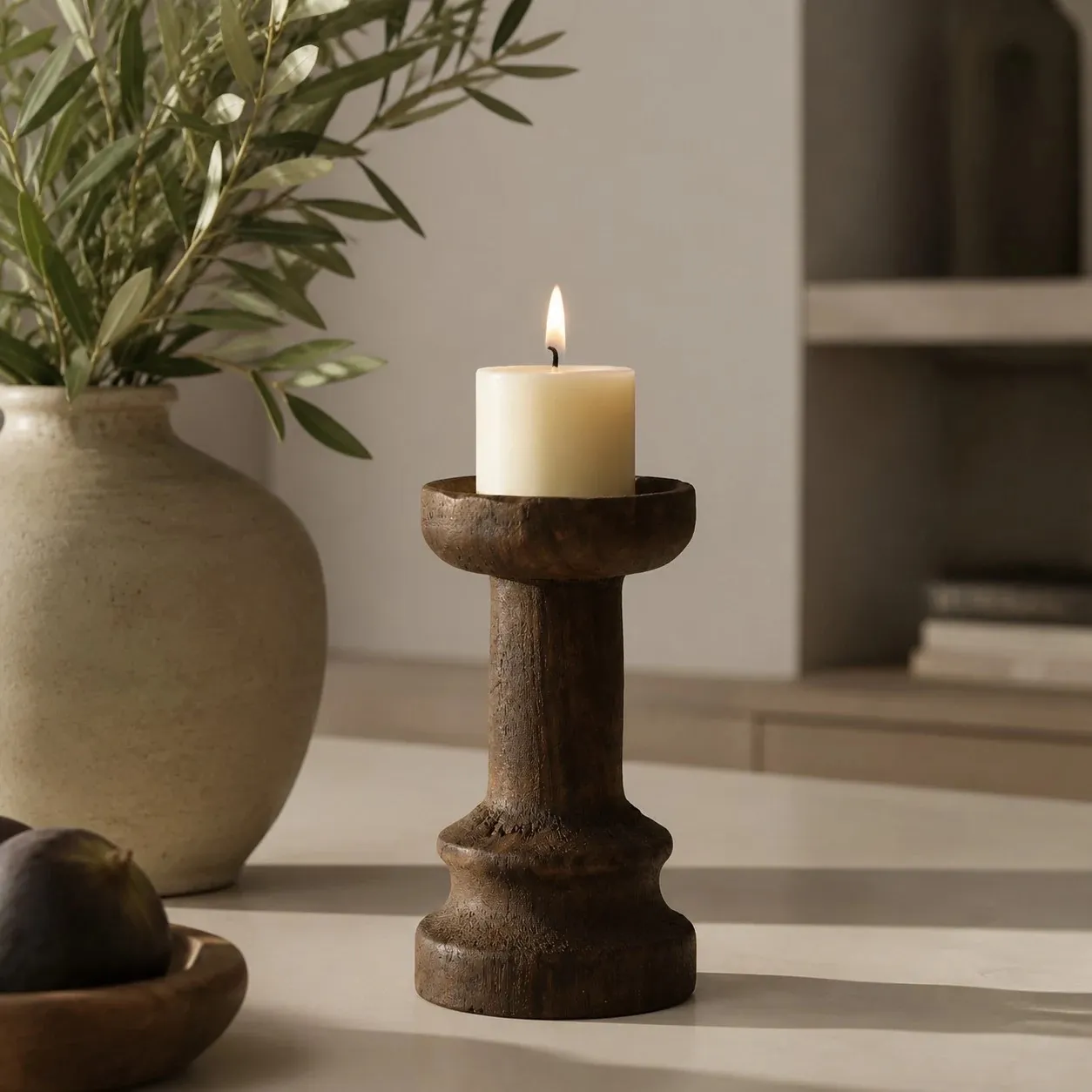 Solid wood candle holder in a calm sunlit tabletop setting; candle not included
