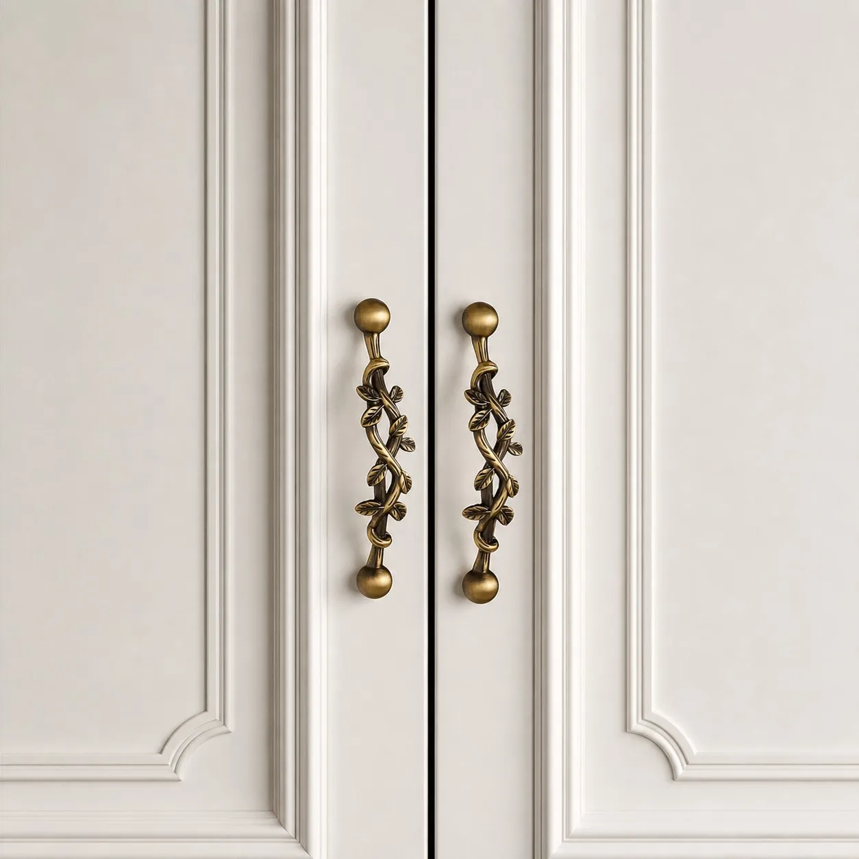 Pair of leaf brass cabinet pulls installed on double doors