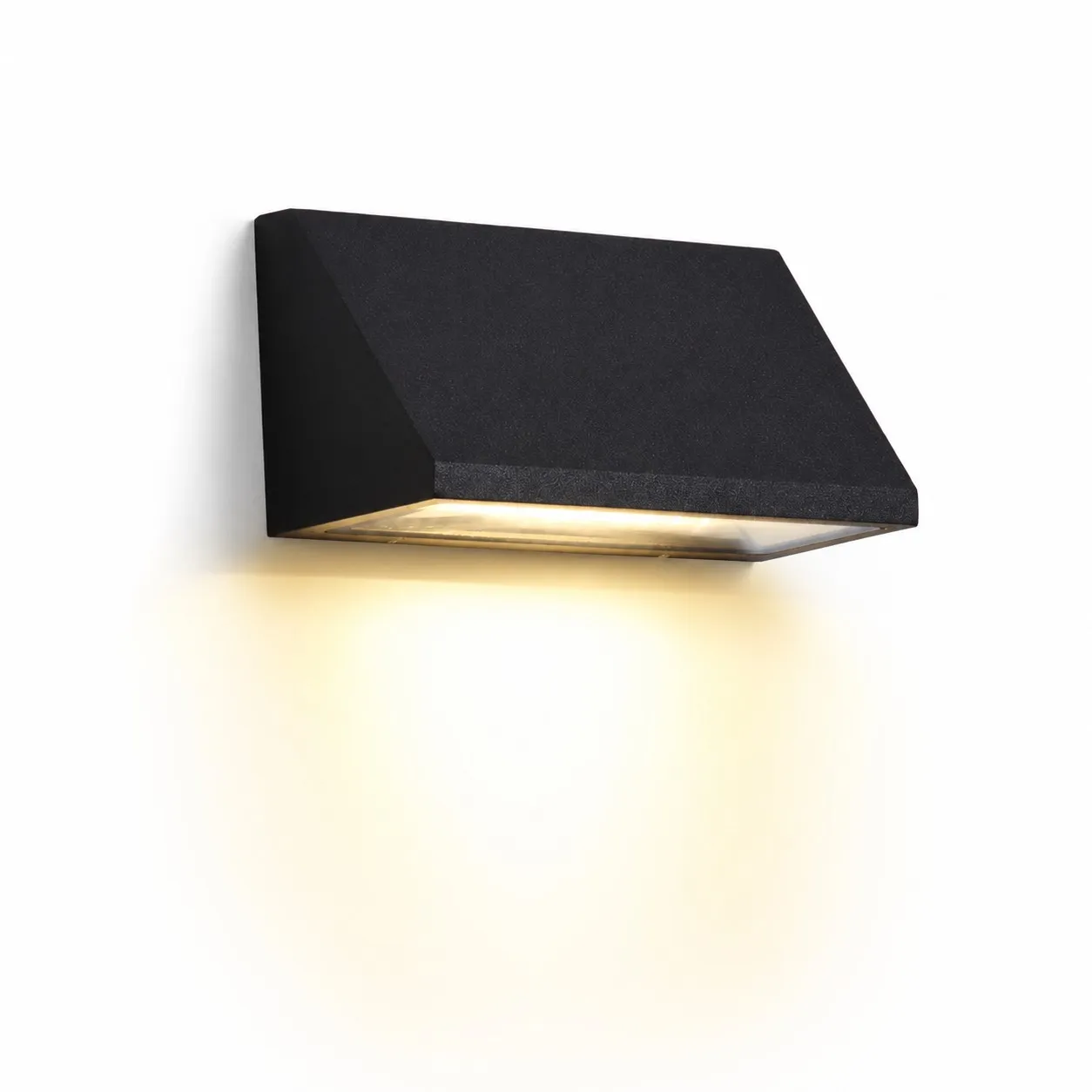 Black wall light glowing on an exterior wall at night