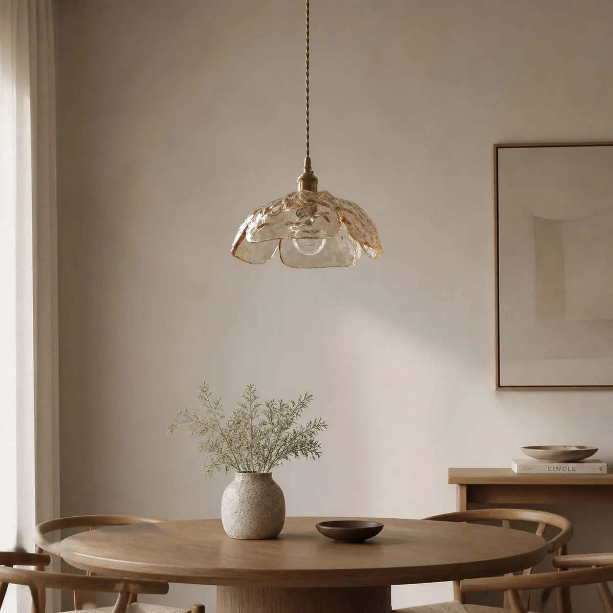 Clear walnut-accent pendant in a calm dining space