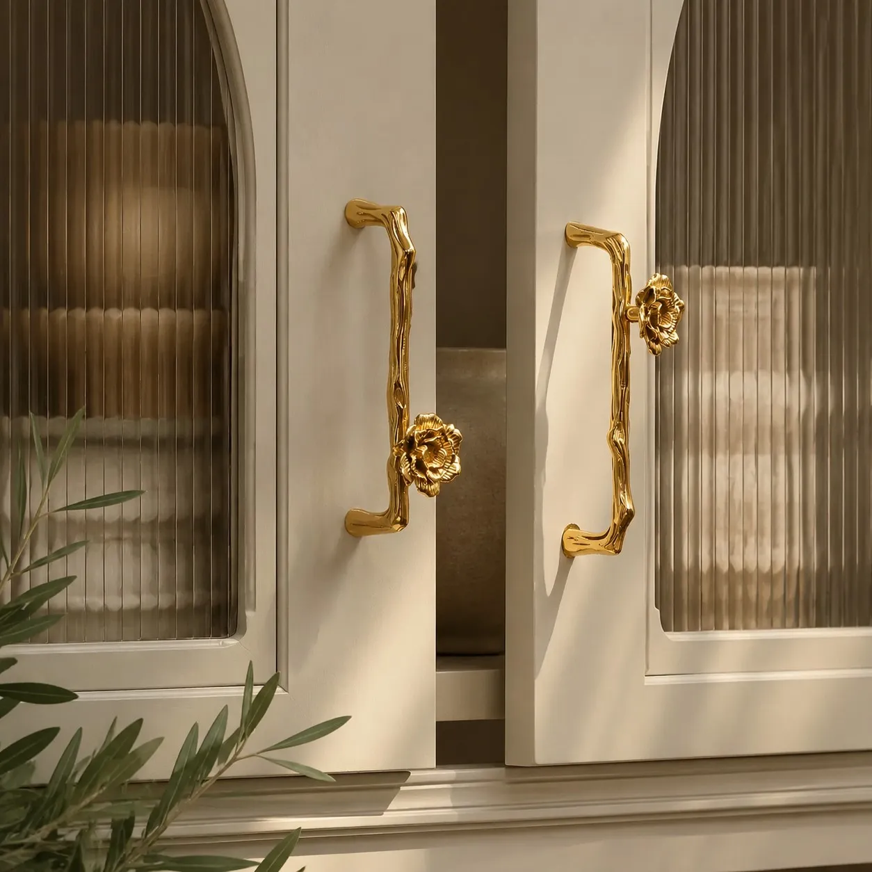 Sculptural brass cabinet handle installed on furniture