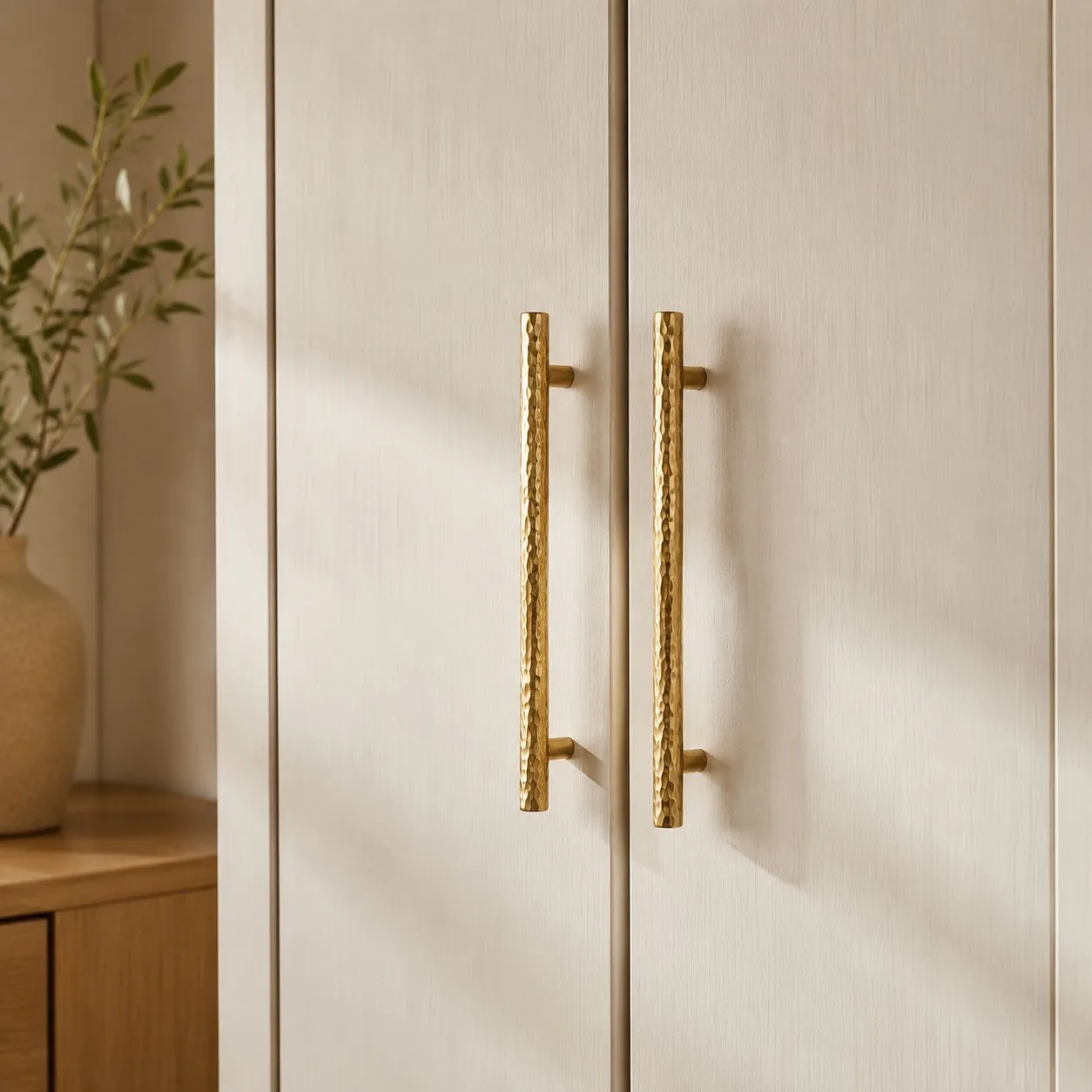 Natural Brass hammered bar pulls installed on wardrobe doors